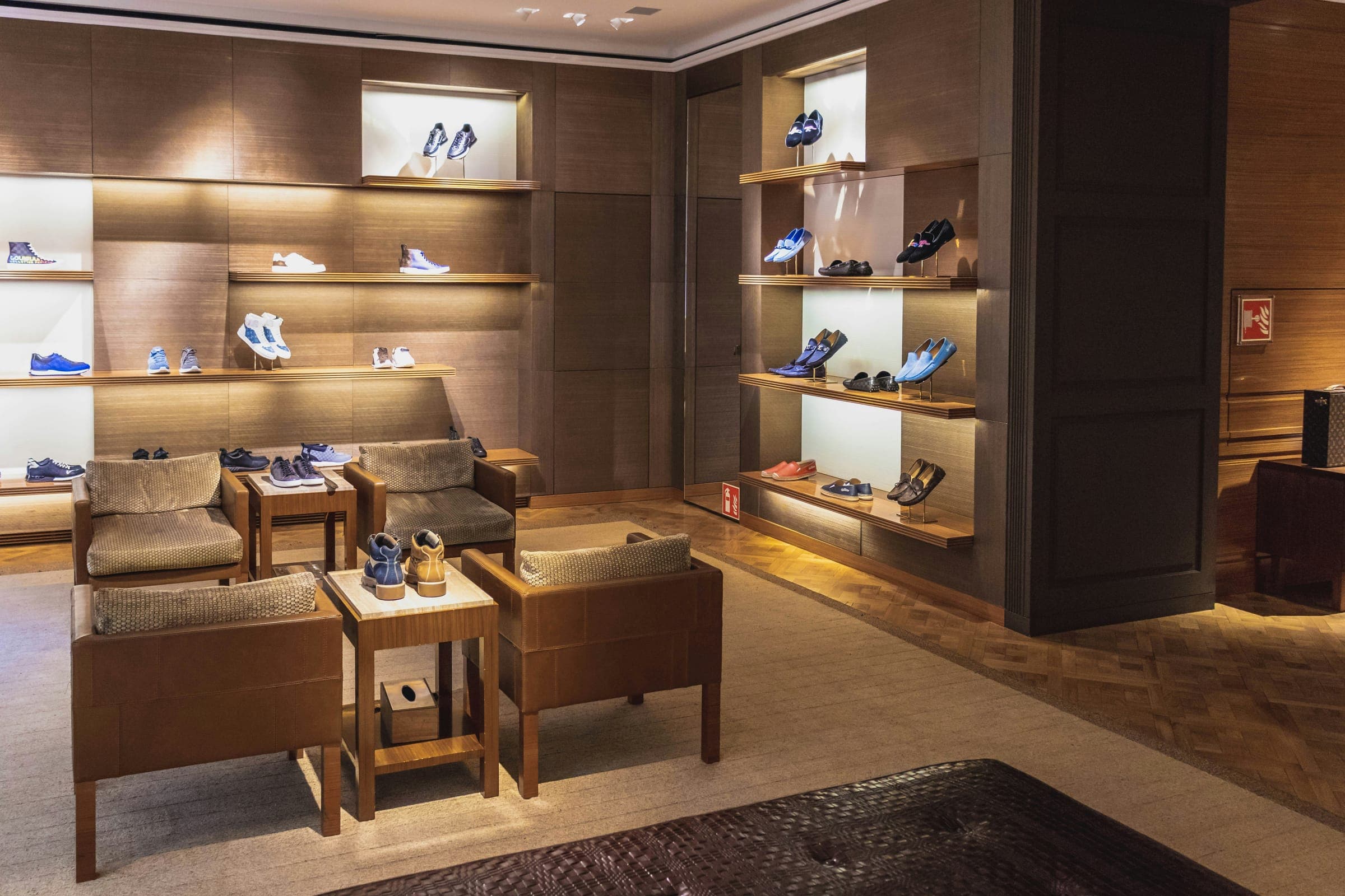 Boutique interior with lit wall niches, display tables and seating